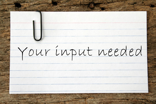 "Your input needed" written on note card