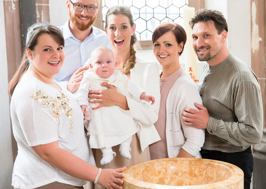 family on child's Baptism day - Kzenon/Shutterstock.com