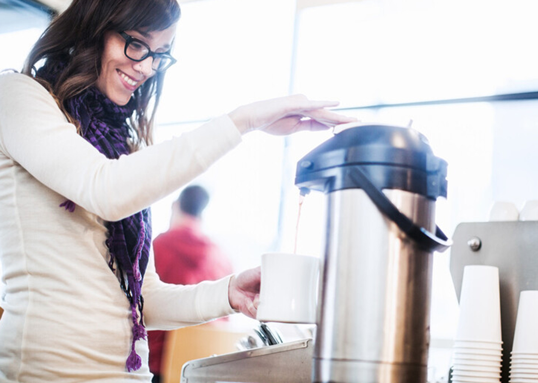 young adult woman getting coffee - RyanJLane/E+/Getty Images