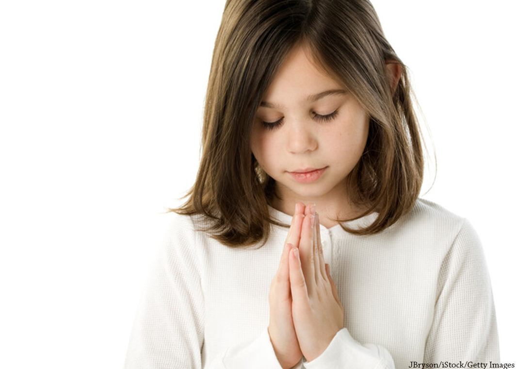 young girl praying - JBryson/iStock/Getty Images