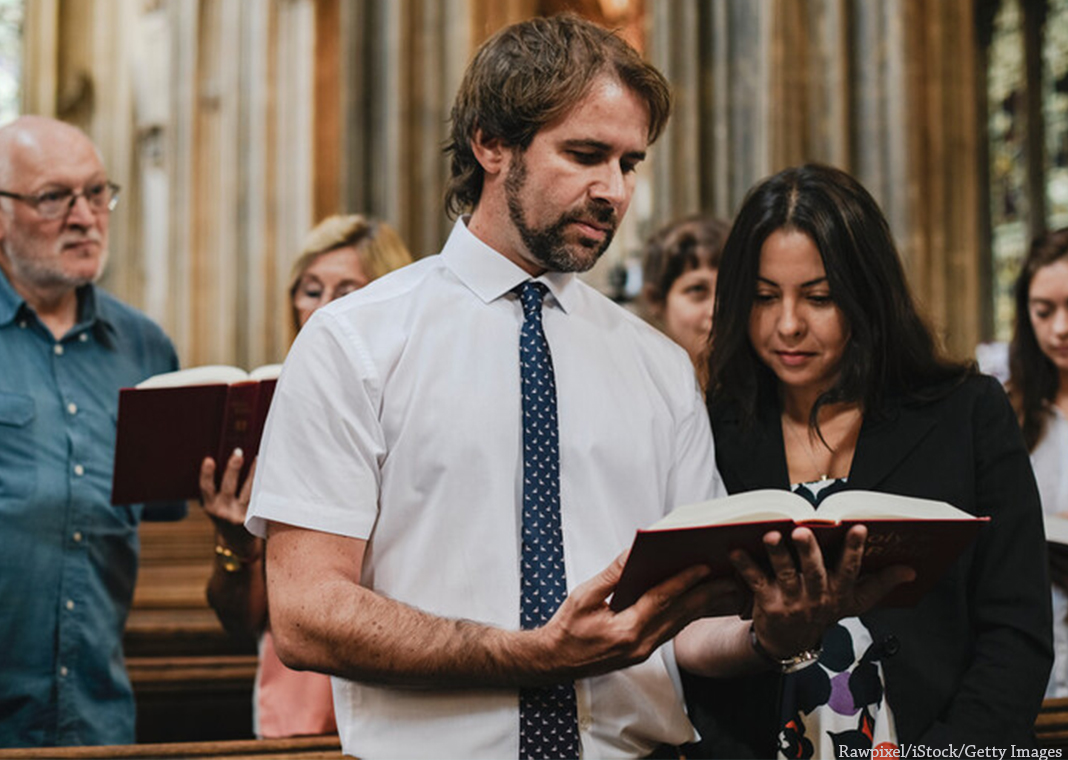 group prayer in church - Rawpixel/iStock/Getty Images