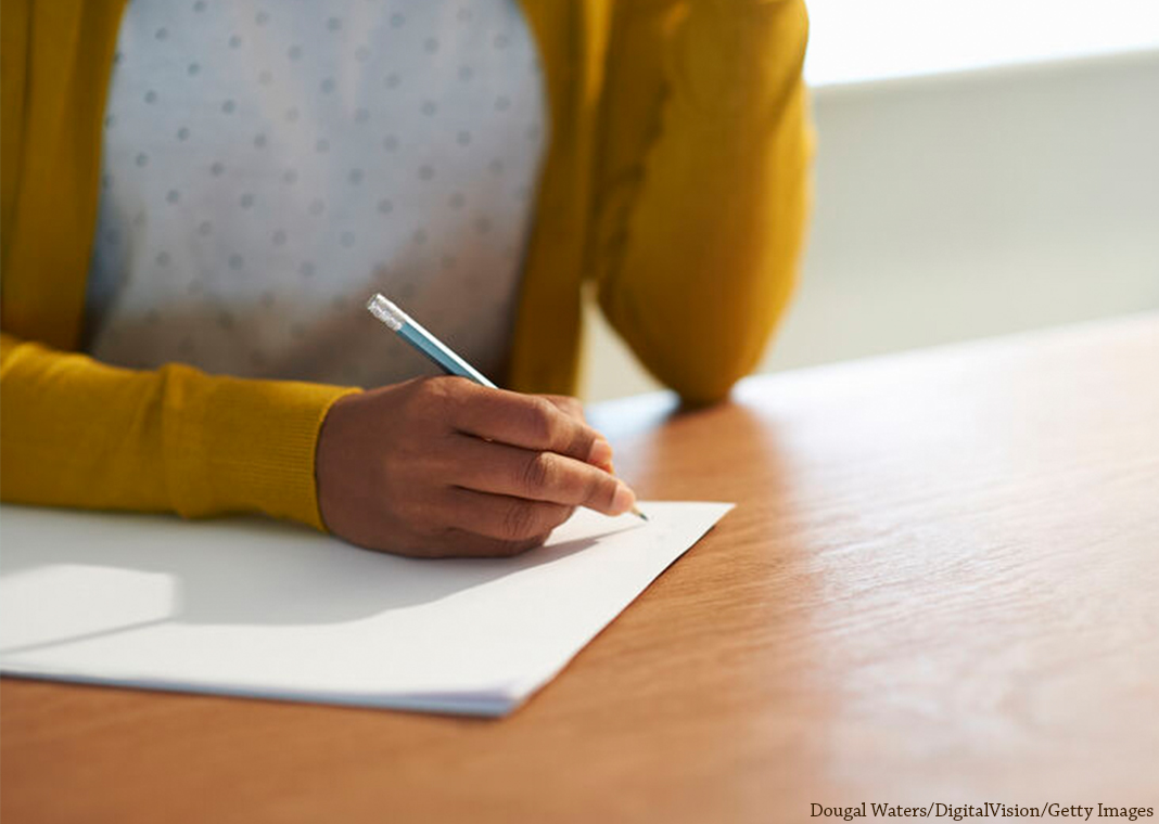 close-up on hand of woman planning on paper - (c) Dougal Waters Photography Ltd
