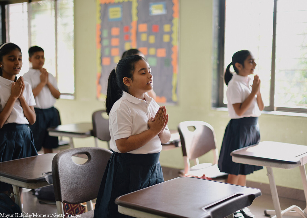 students praying in classroom - Mayur Kakade/Moment/Getty Images