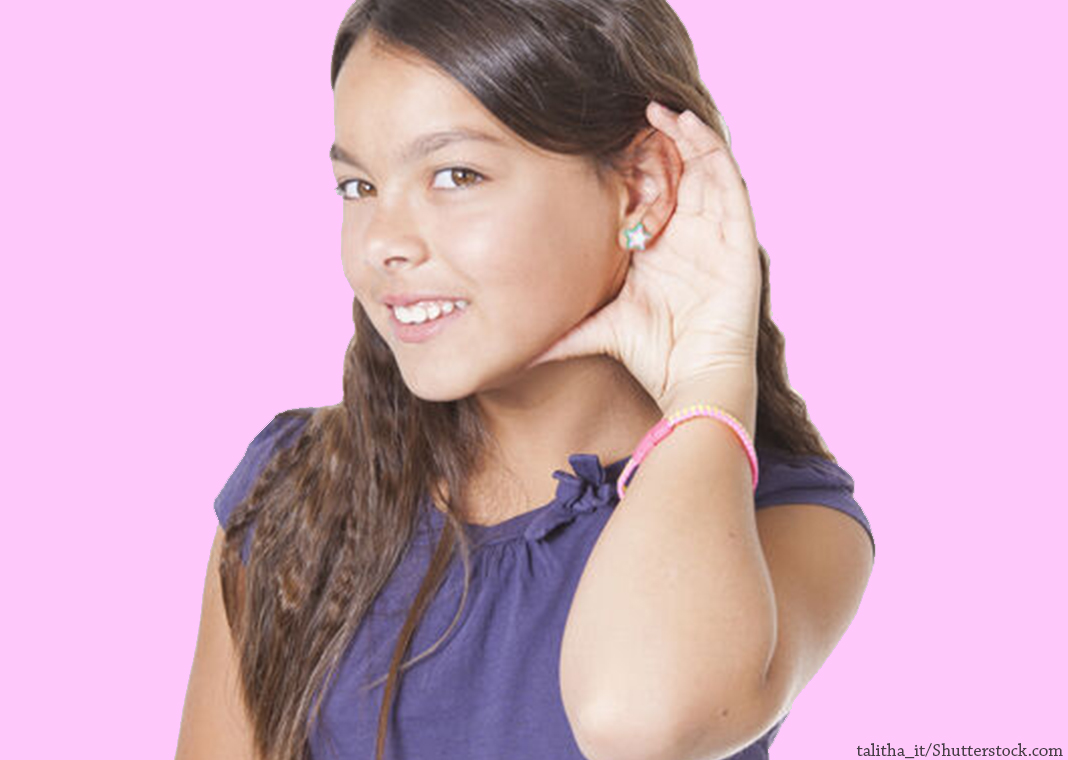 girl with hand to her ear in a position of listening - talitha_it/Shutterstock.com