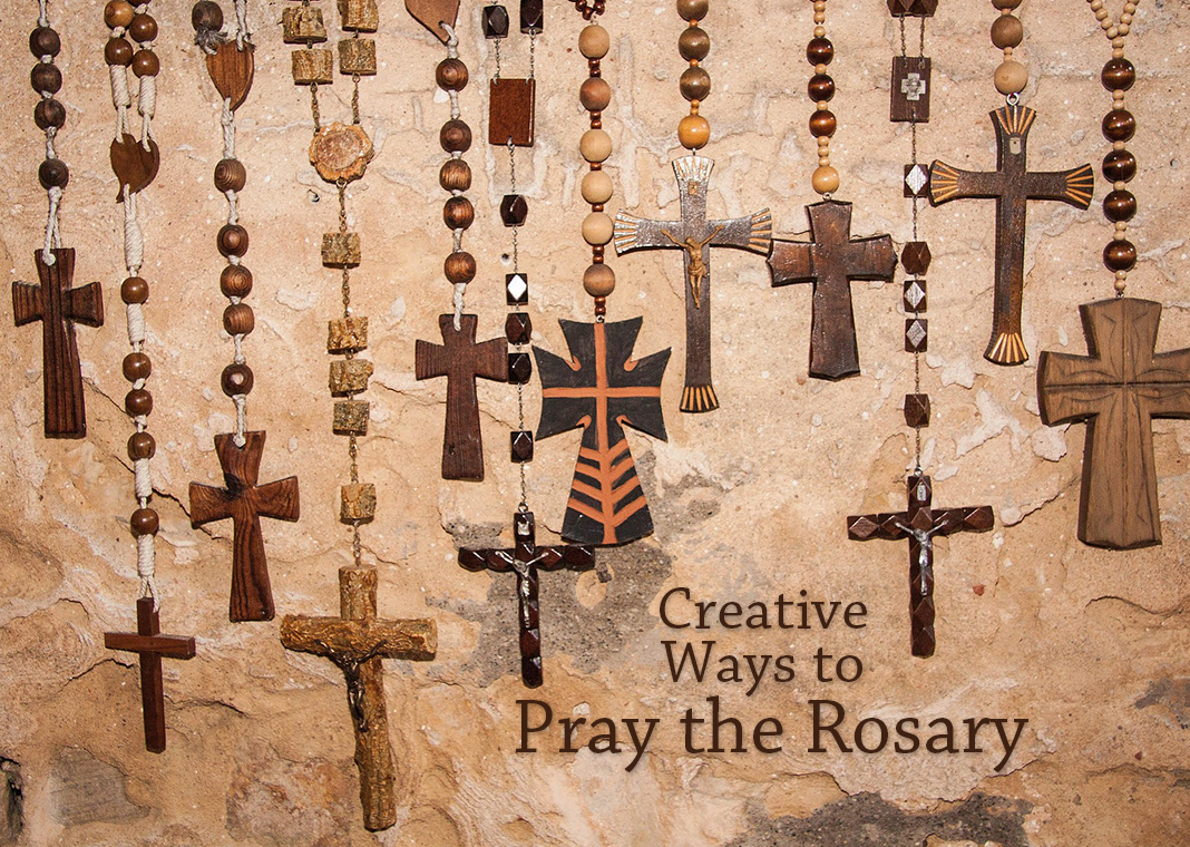 Creative Ways to Pray the Rosary - several rosaries hanging on wall - image by Stefan Schweihofer from Pixabay