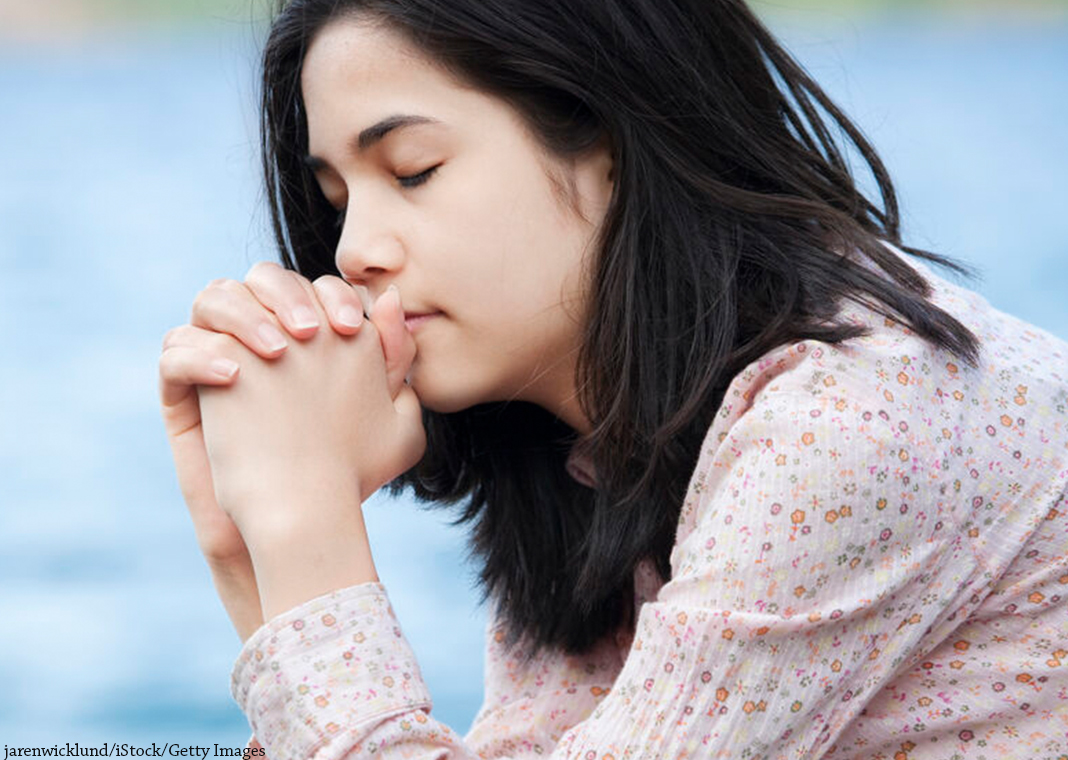 teen girl praying in silence - jarenwicklund/iStock/Getty Images