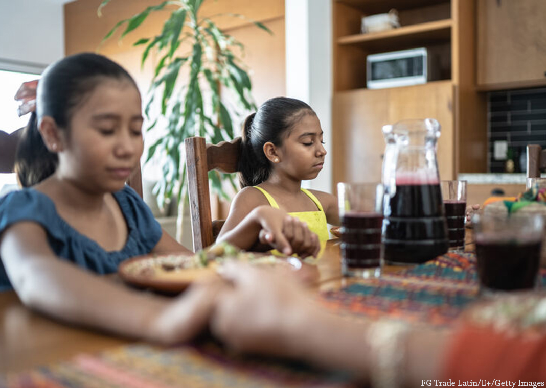 family praying at dinner table - FG Trade Latin/E+/Getty Images