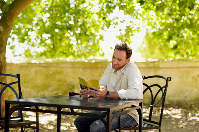 man-reading-outdoors