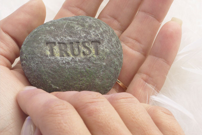 word "trust" on rock