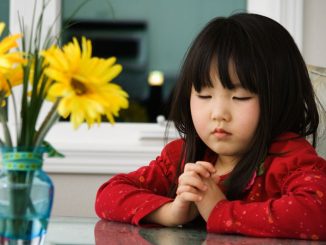 child in reflective prayer