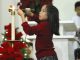 girl lighting candle at Christmas Mass