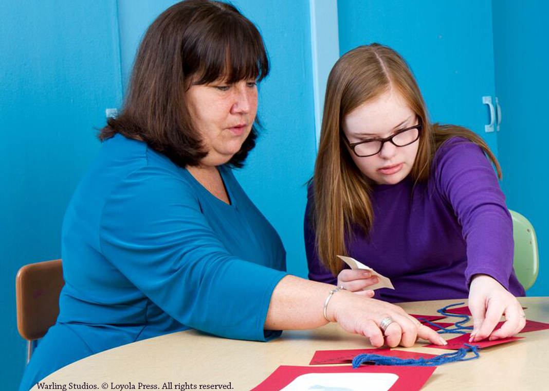 catechist and young person work on a craft project - Warling Studios. © Loyola Press. All rights reserved.