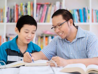 teacher helping student in library