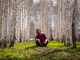 woman sitting under trees - photo by Baurzhan Kadylzhanov from Pexels