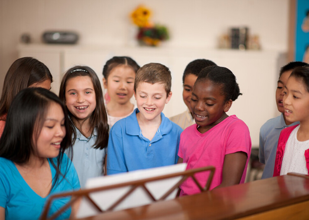 choir director leading children in song - Christopher Futcher/ FatCamera/E+/Getty Images